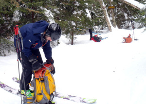 On the trail down, we stopped to remove skins before skiing the steepest section of the trail. David tried to take his off without removing his skis. The results were entirely predictable . . . (EasternSlopes.com photo)