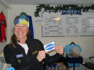 Caroline Marston, the friendliest of ticket sellers, holds up a Carpe Skiem sticker. 100