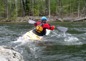 Zoar instructor Ben Natusch demonstrates how to lean the boat and "peel out" of an eddy behind a big rock in fast current. (EasternSlopes.com)