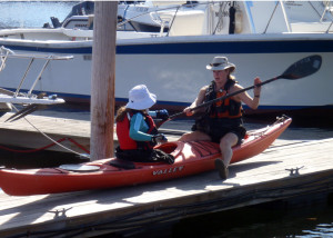 A good kayak instructor gets up close and personal. Here Theresa Willette of Coastal Maine Kayak helps student Marilyn Donnelly with her paddle technique. (EasternSlopes.com)