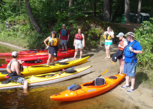 Before the students took to the water, Instructor Jeff Brent of Contoocook River Canoe Co. explains the basics of getting into and out of a kayak in an Introduction to Kayaking course. (EasternSlopes.com)
