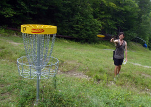 Visiting from Sydney, Australia, Phil "tree-nied" White, who earned his nickname for hitting trees with his flying disc, takes aim at the 17th hole on the championship Disc Golf course at Mount Sunapee in Newbury, NH. He missed the putt and bogied the hole . . . (EasternSlopes.com)