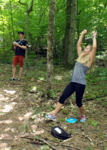 Alex "lady arms" Peters, who is visitng from Sydney, Australia, celebrates as she sinks a put for par on the Disc Golf course at Mount Sunapee in Newbury, NH. Fellow Aussie Max "pitch and putt" Halden also applauds her success. (Tim Jones/EasternSlopes.com photo)