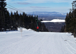 Riding the T-bar at Saddleback Maine. The sun is on your face and the cold north wind is behind you as you ride up on a day when other lifts are on wind hold. (Tim Jones/EasternSlopes.com)